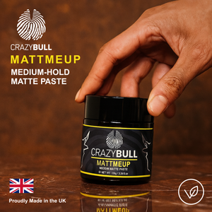 Crazy Bull MattMeUp medium-hold matte paste jar with hand holding it on a wooden surface.