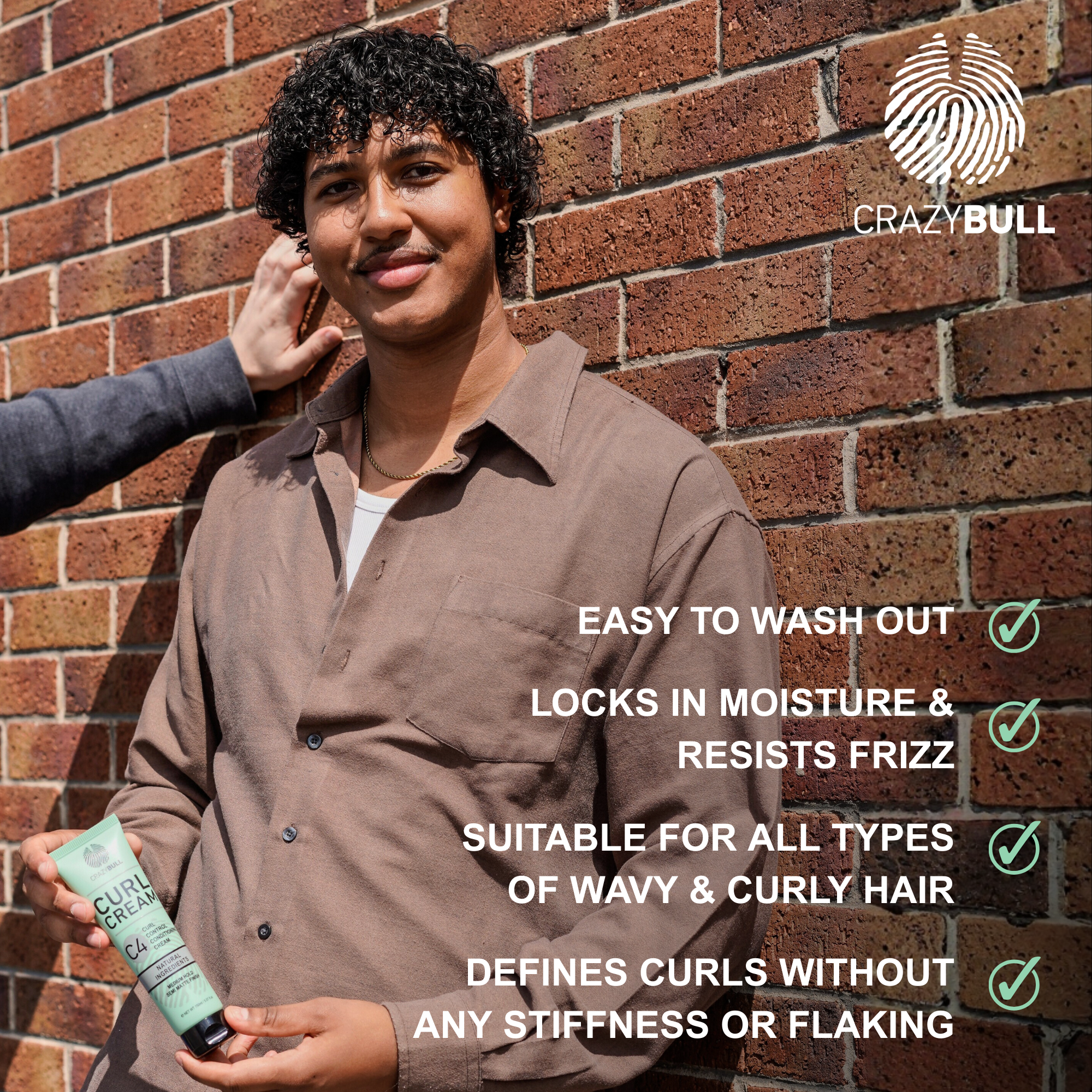 Man holding C4 Curl Cream with text about hair care features against a brick wall, featuring the Crazy Bull brand.